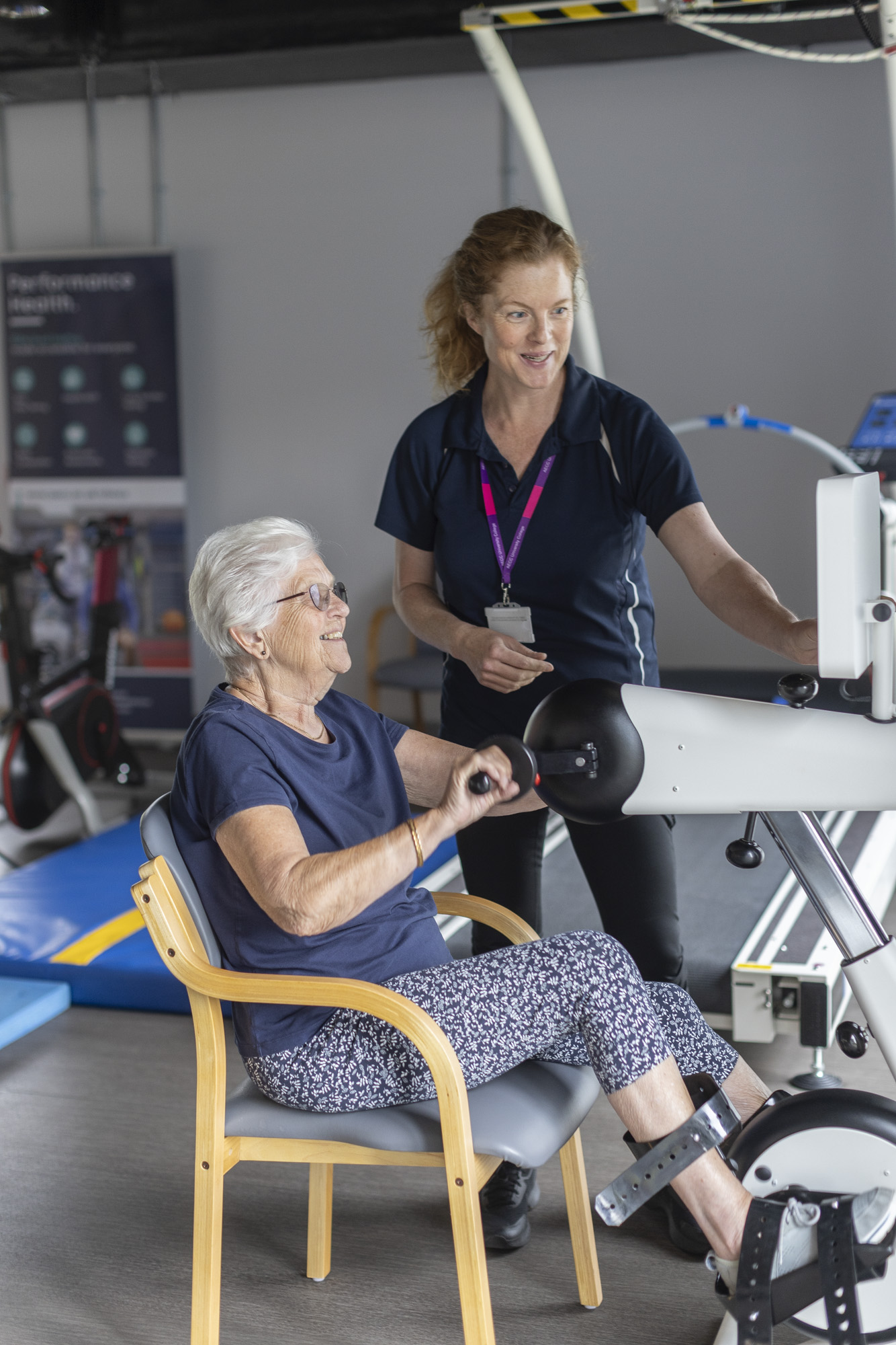 clinician and patient on exercise machine