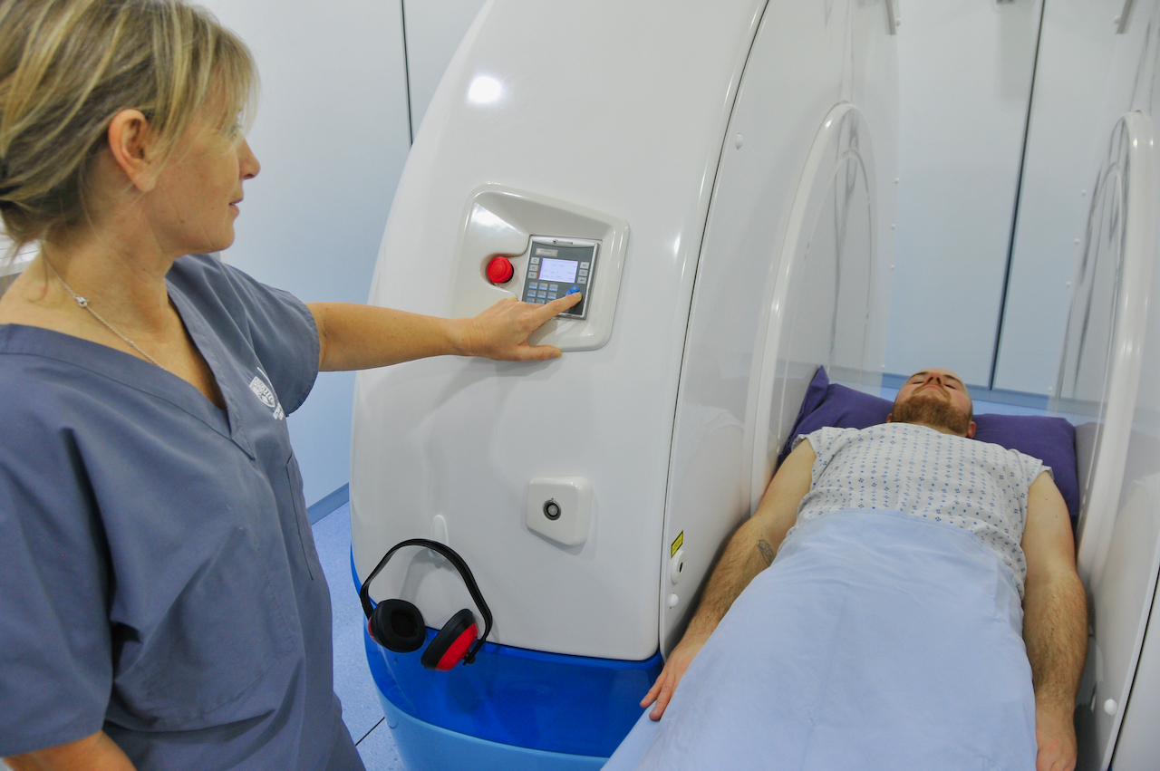 open MRI machine with patient lying down