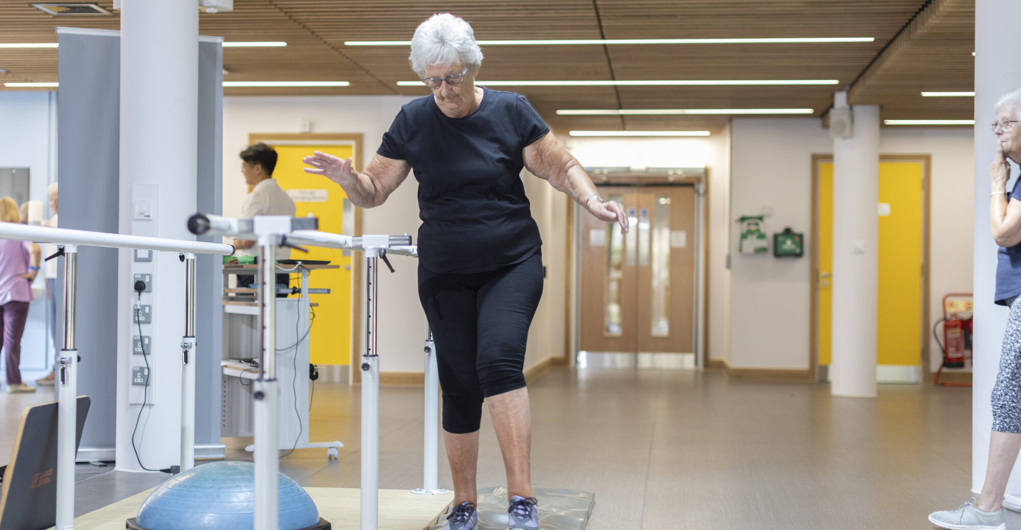Older adult performing balance exercises in rehabilitation setting