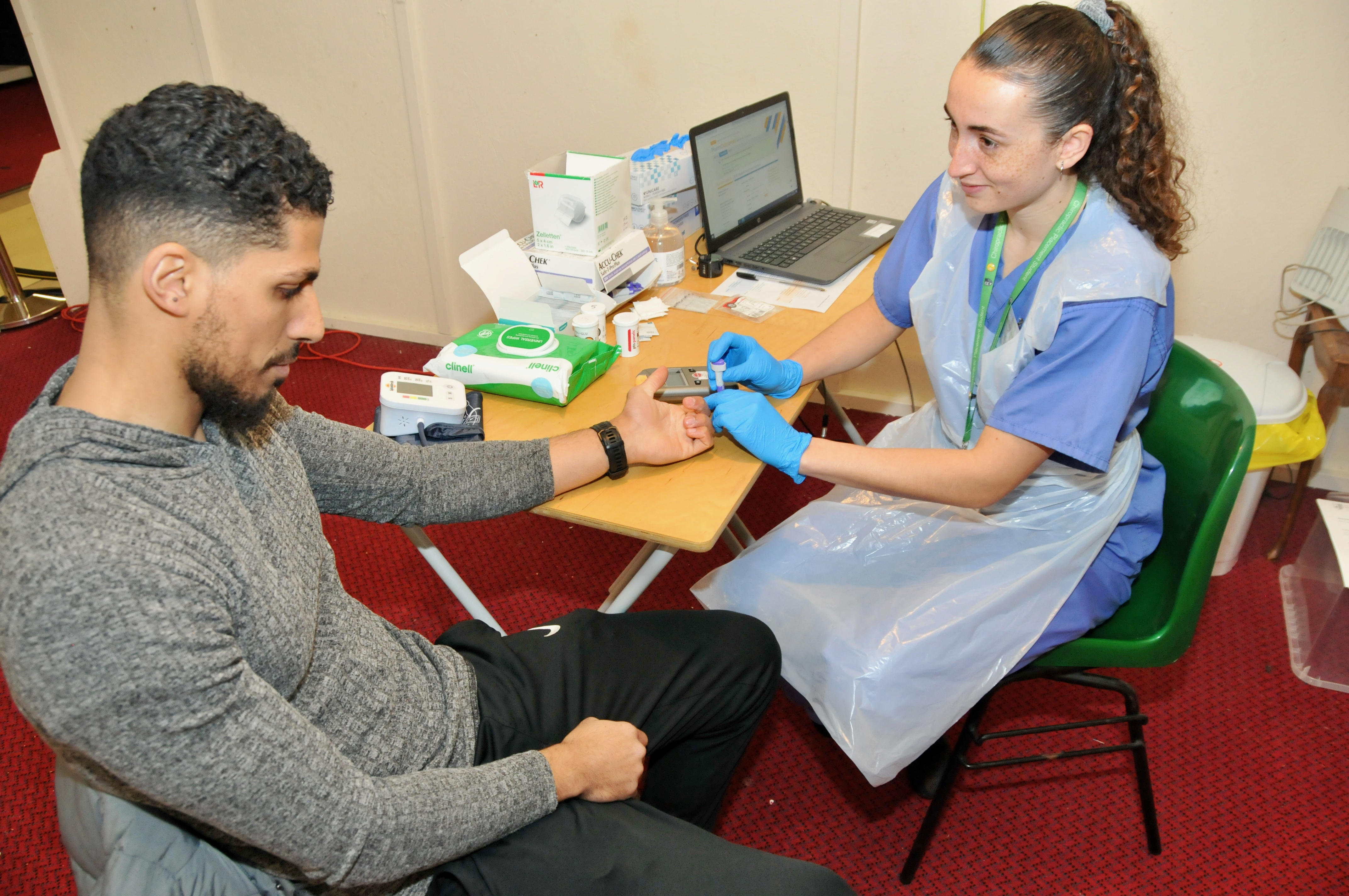man receiving health test from clinician
